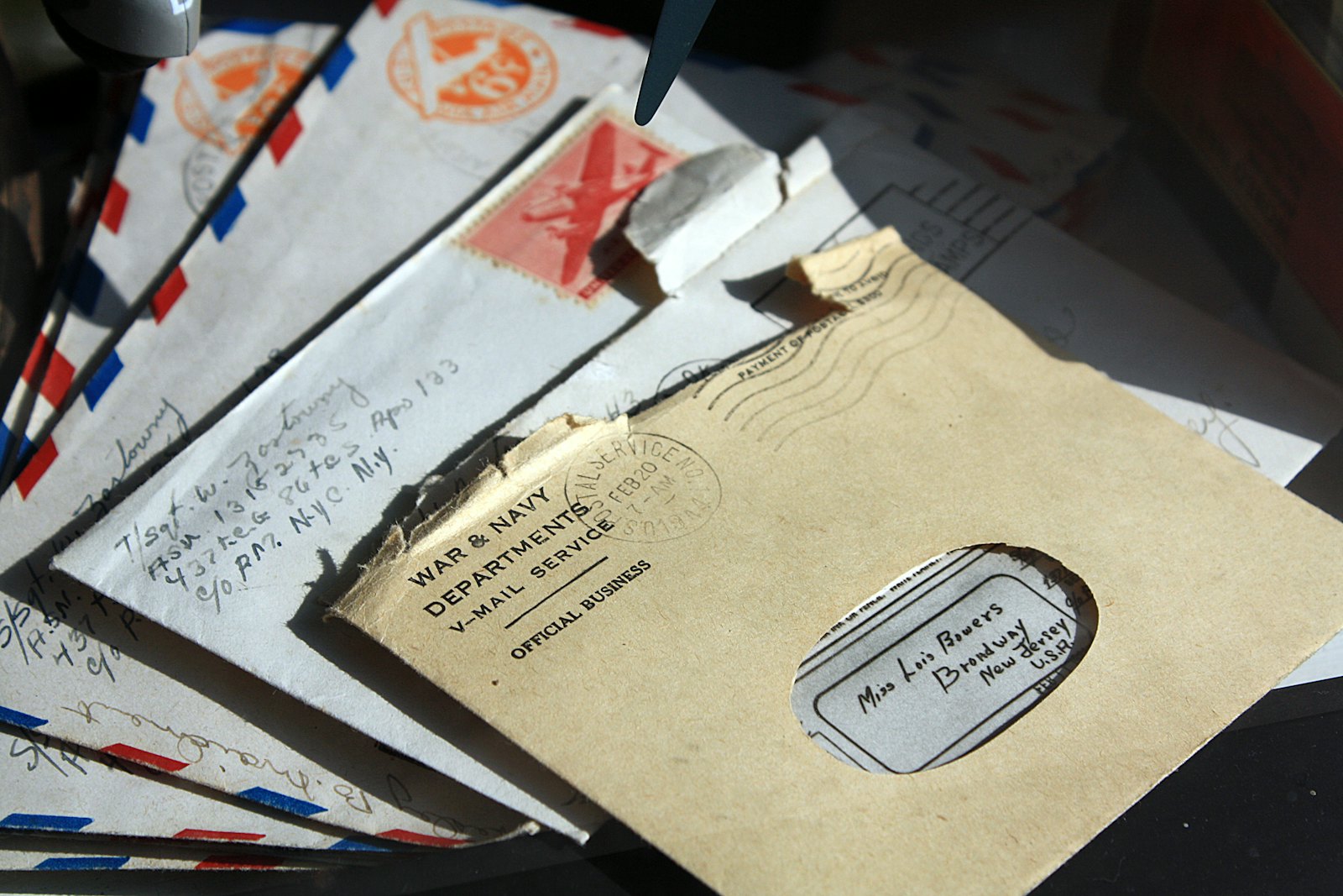 Opened envelopes and a handwritten letter resting on a desk